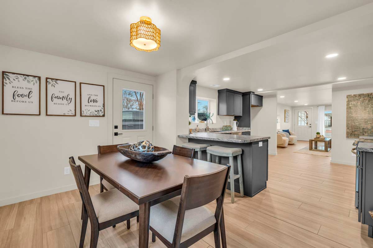 A spacious kitchen and dining room featuring elegant hardwood floors, creating a warm and inviting atmosphere.