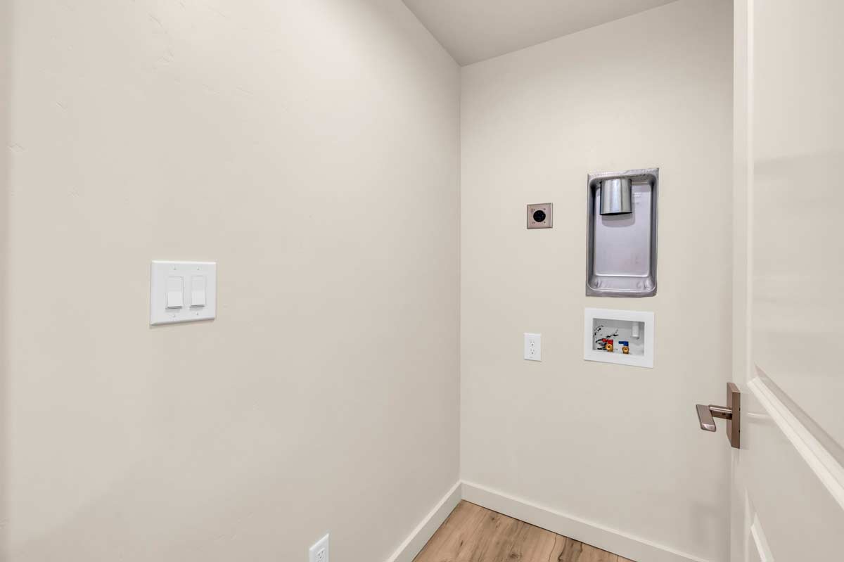 A hallway featuring a white door against a pristine white wall, creating a clean and minimalist aesthetic.