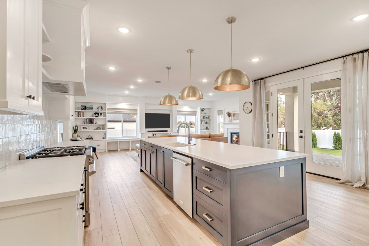 A sophisticated kitchen featuring elegant white cabinets and warm wooden floors, exuding a timeless charm and luxury.