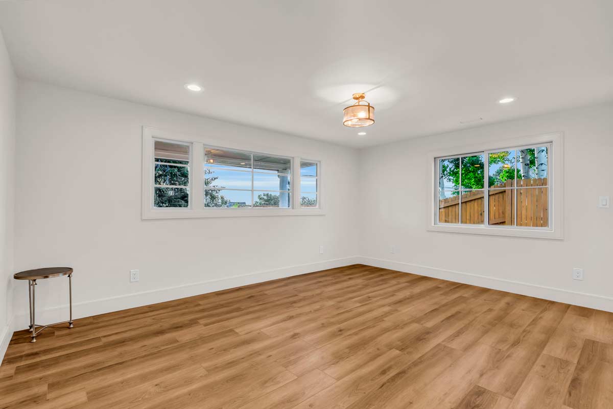 Empty room featuring hardwood floors and white walls, creating a bright and spacious atmosphere.