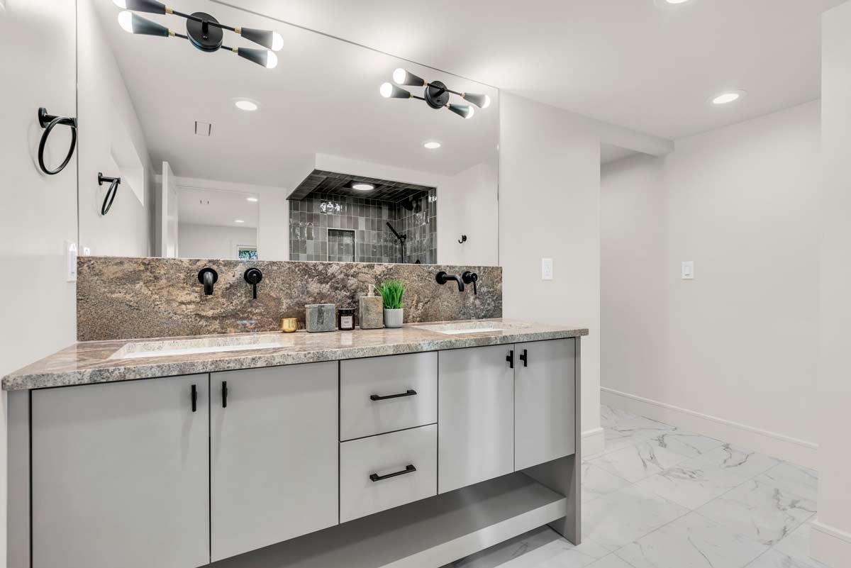 A luxurious bathroom featuring elegant marble countertops and pristine white cabinets, exuding sophistication and style.