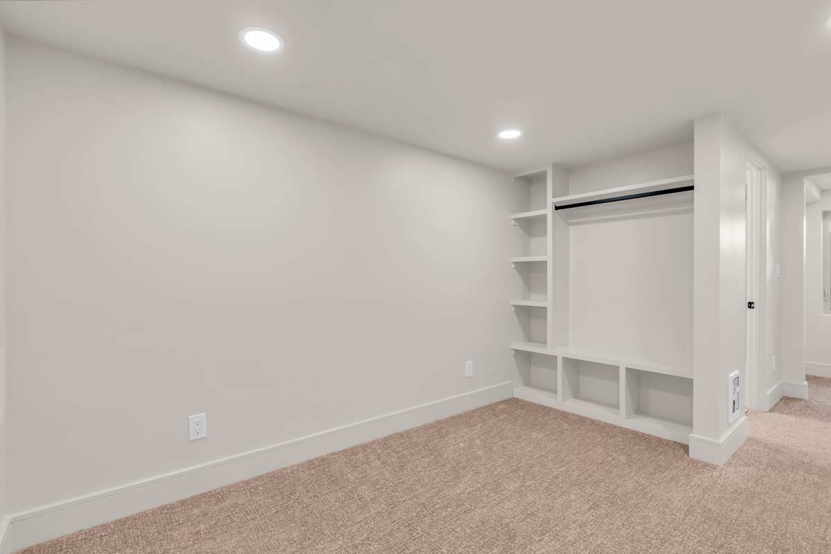 A tidy room featuring a closet and organized shelves, showcasing a neat and orderly environment.