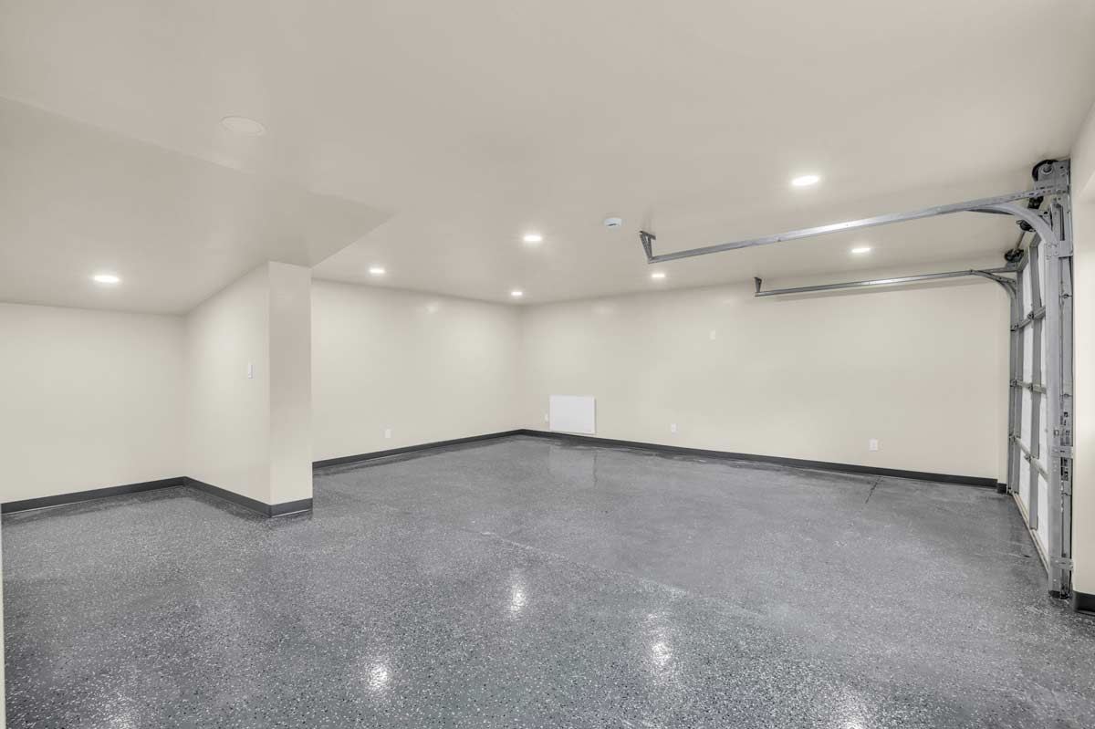 A garage featuring gray walls and a ceiling fan, creating a cool and functional space for various activities.