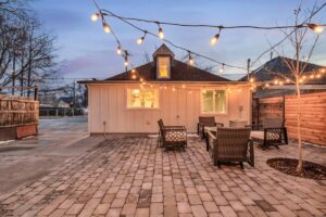 City Park Restoration, UT 2 A charming backyard adorned with elegant patio furniture and twinkling string lights, perfect for serene evenings.