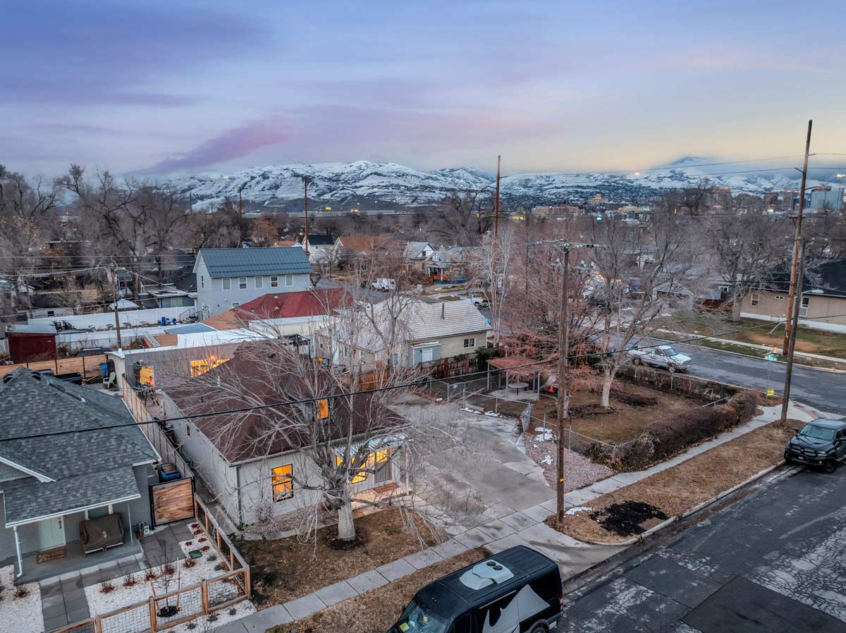 A picturesque neighborhood featuring charming houses with majestic mountains rising in the background, embodying serene elegance.