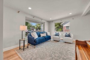 A cozy living room featuring a blue couch, creating a harmonious and inviting atmosphere.