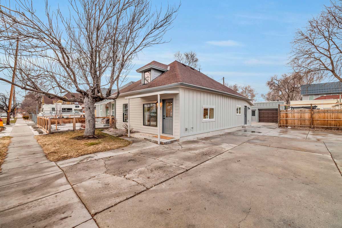 A house featuring a garage and a paved driveway, showcasing a welcoming residential environment.