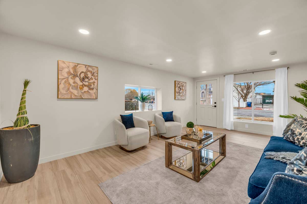 A cozy living room featuring blue couches and a matching blue rug, creating a harmonious and inviting atmosphere.
