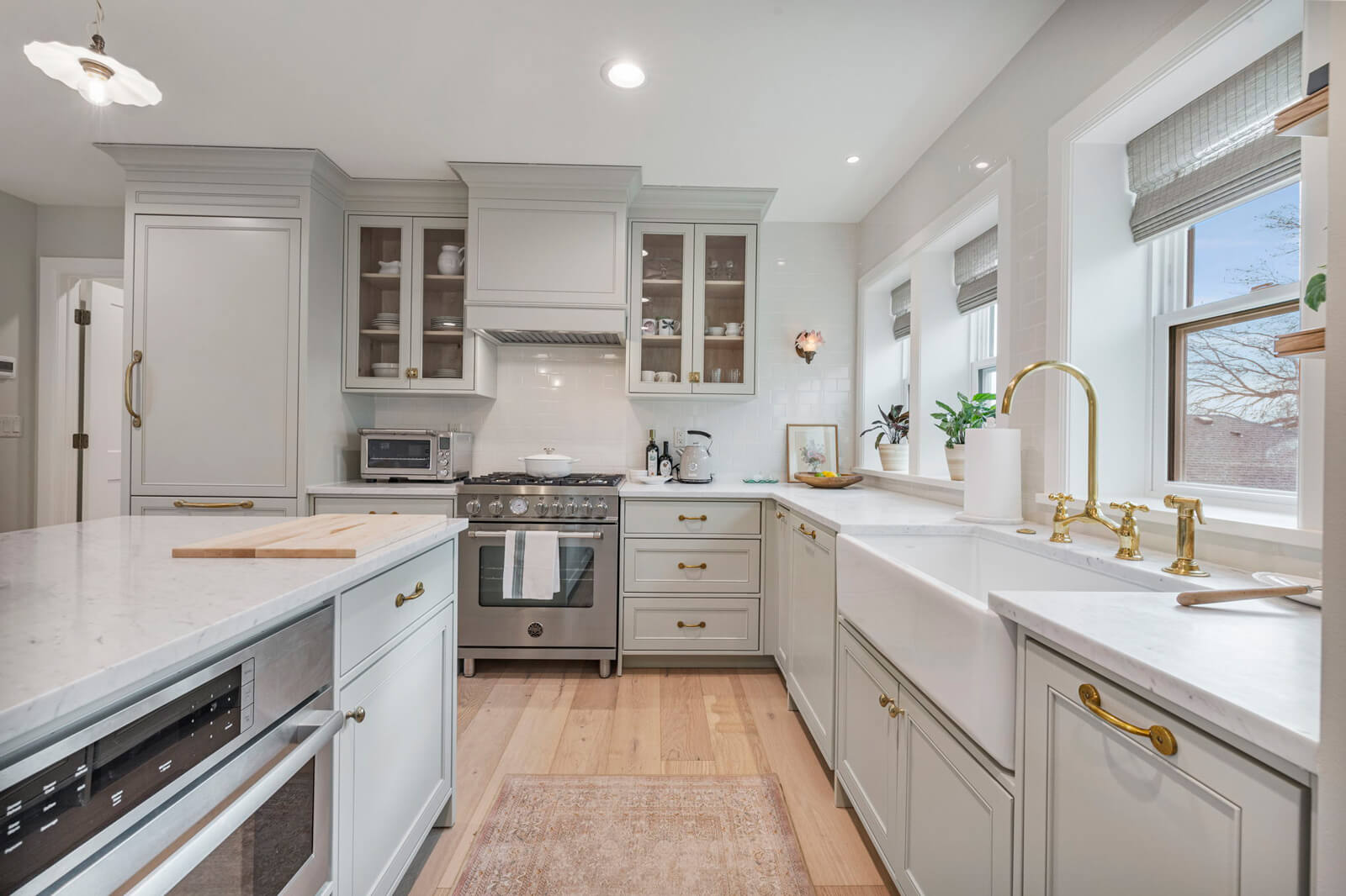 A modern kitchen featuring white cabinets and a spacious central island, creating an inviting cooking space.