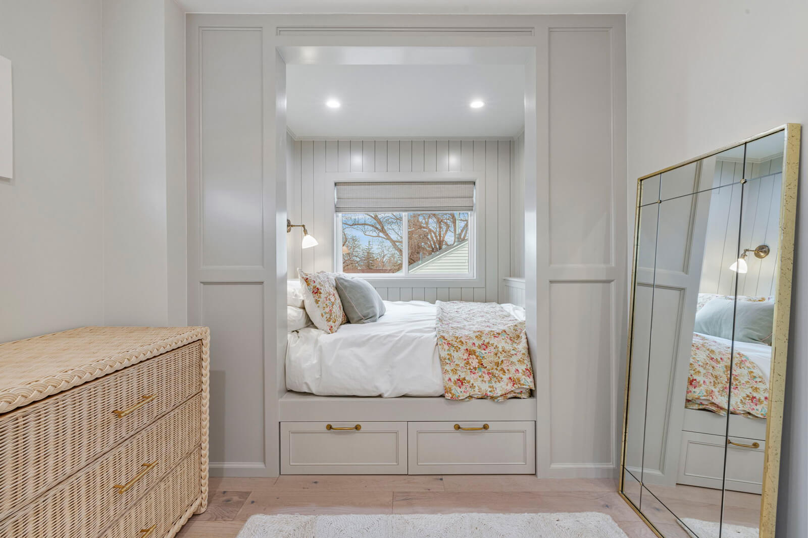 An inviting bedroom with a plush bed and a chic mirror, creating a harmonious and relaxing environment.