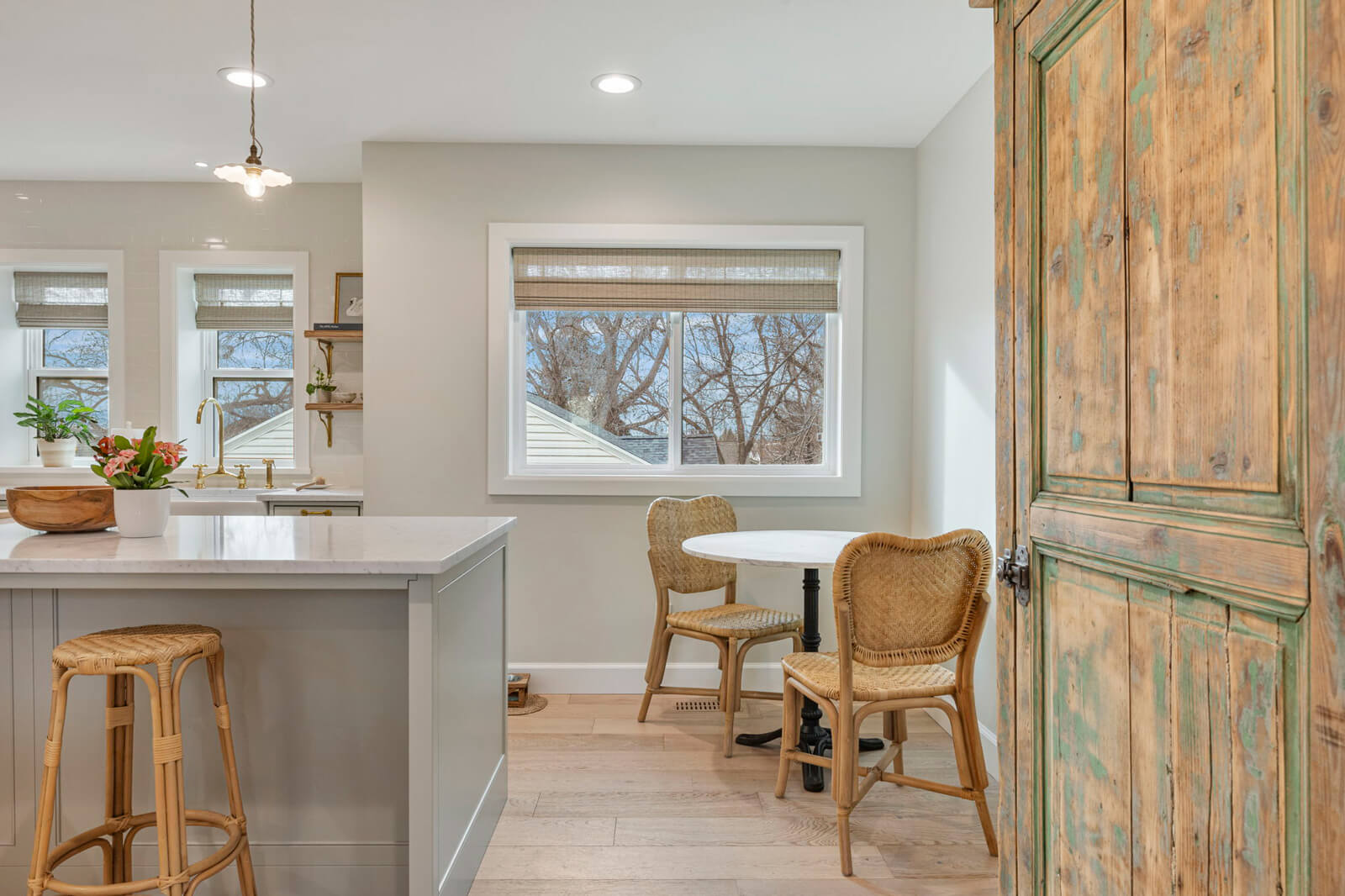 A modern kitchen featuring a white countertop and a white couch, creating a bright and inviting atmosphere.