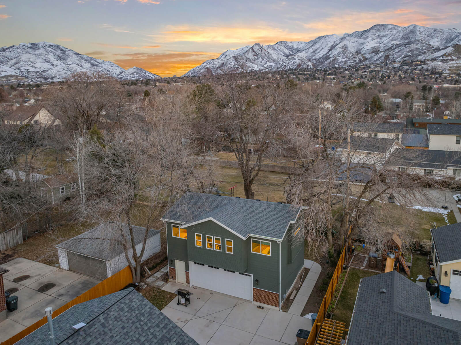 A house with an attached garage and a neatly paved driveway, emphasizing a suburban lifestyle.