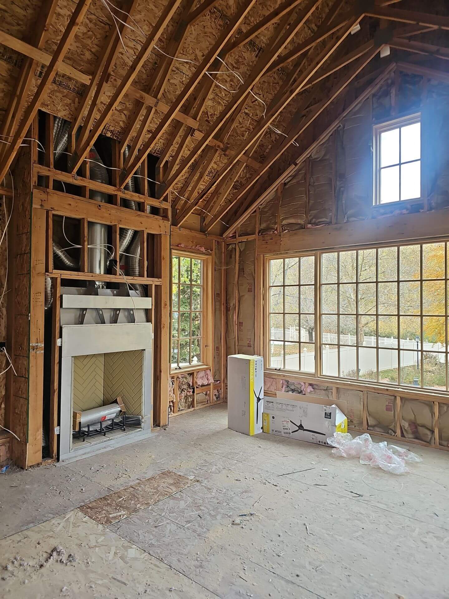 A cozy room featuring exposed wood beams and a warm fireplace, creating an inviting atmosphere.