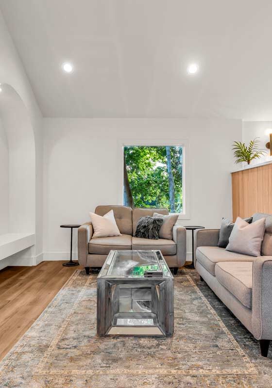 A cozy living room featuring a warm fireplace and a sleek television, exuding elegance and comfort.